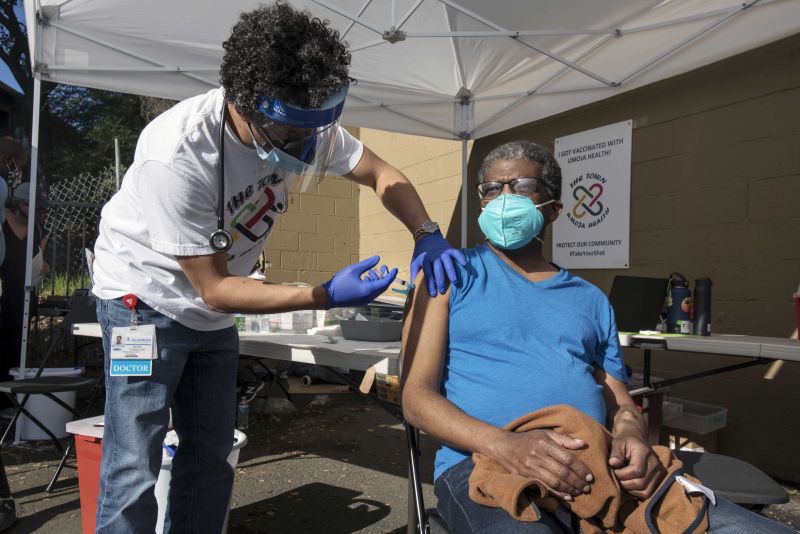 Person receives covid vaccine outside credit Mark Leong Redux SMALL